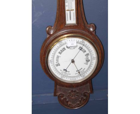 20TH CENTURY CARVED OAK BAROMETER
with carved foliate and floral motifs, 82cm high