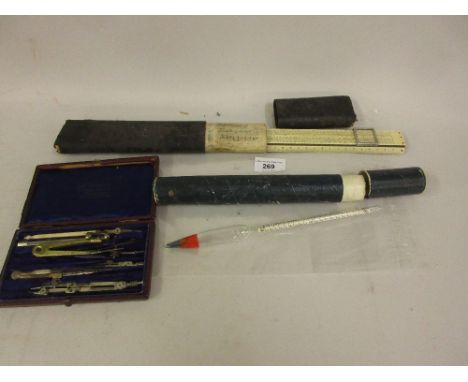 Cased slide rule, cased thermometer and a leather cased part drawing instrument set 