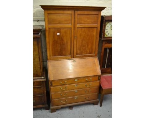 George III satinwood bureau bookcase, the moulded cornice above a pair of panelled doors, the fall front enclosing a fitted i