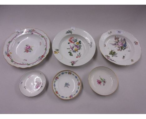 Two Meissen soup bowls with painted floral decoration (at fault), together with a similar plate and three saucers 