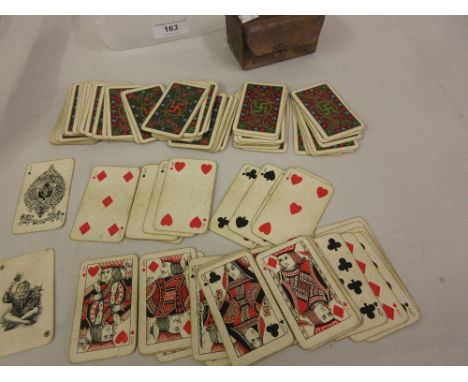 Boxed set of miniature playing cards decorated with a swastika motif together with a pair of reproduction gilt brass twin lig