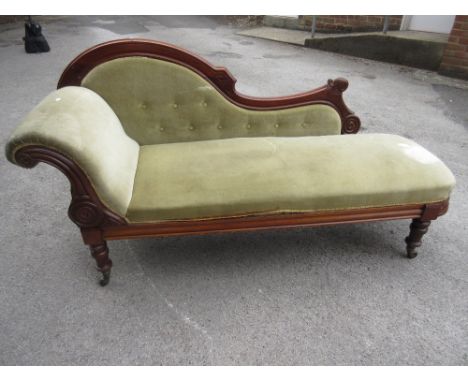 Victorian mahogany chaise longue with green button upholstered back, upholstered seat and a single scroll arm raised on turne