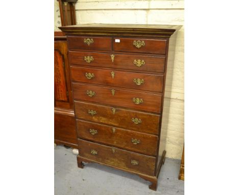 George III mahogany tall chest with a moulded cornice above two short and six long graduated drawers with brass handles and e