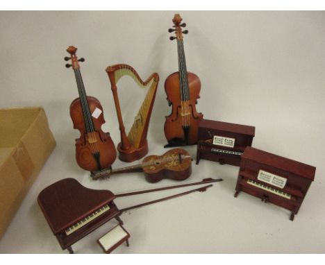 Group of four modern musical boxes in the form of a cello, violin, harp and a guitar 