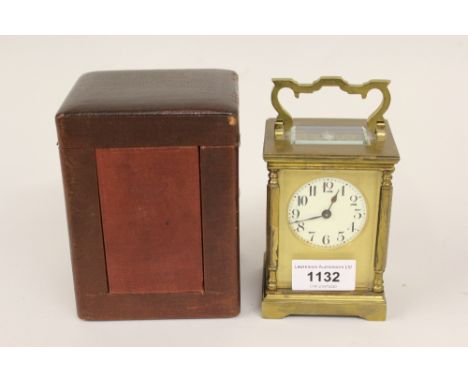 Gilt brass carriage clock, the circular dial with Arabic numerals, housed in original leather travel case 