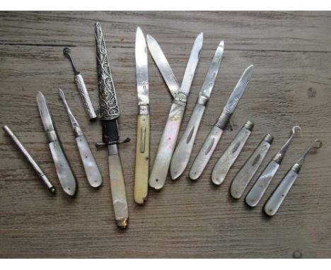 Two silver and steel double bladed knives, four various button hooks, one silver cased tweezer, two silver and mother of pear