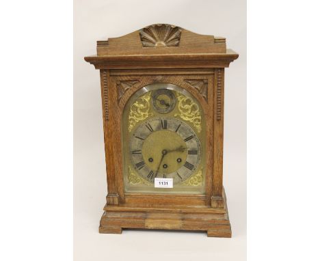 Early 20th Century oak bracket clock, the gilded and silvered dial with Roman numerals, the three train movement striking on 