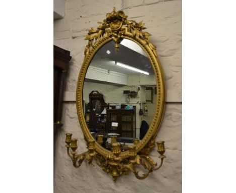 Large Victorian oval gilded composition six light girandole, the shaped surmount of scroll and laurel leaf design, the moulde