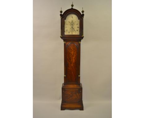 George III mahogany longcase clock, the broken arch hood with flanking pilasters above a figured panelled door flanked by ree