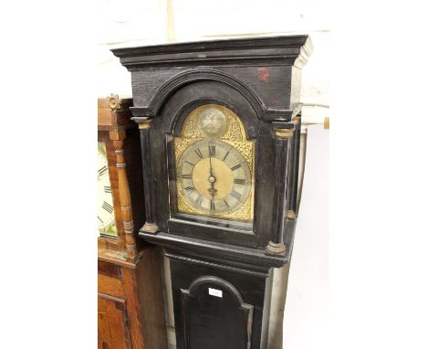 18th Century ebonised longcase clock, the broken arch hood above a moulded panel door and conforming plinth base, the 8in gil