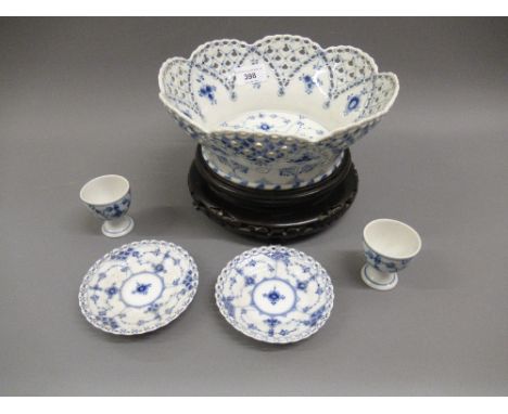 Royal Copenhagen blue and white basket form bowl on a hardwood stand, pair of similar eggcups and two small circular dishesEg