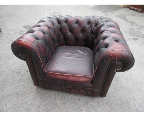 Red button leather upholstered Chesterfield type armchair 
