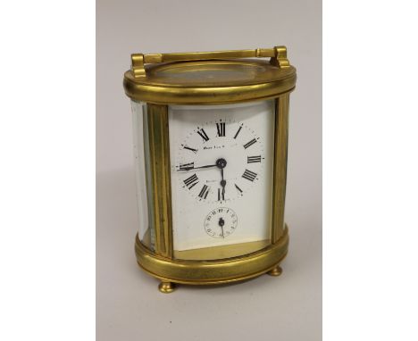 Late 19th or early 20th Century French gilt brass cased carriage clock, the white enamel dial signed West End Watch Co., Bomb