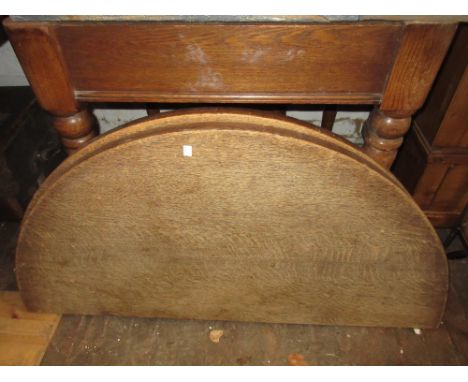 Small Victorian oak wind-out extending dining table, the plain top with a single extra leaf raised on turned tapering support