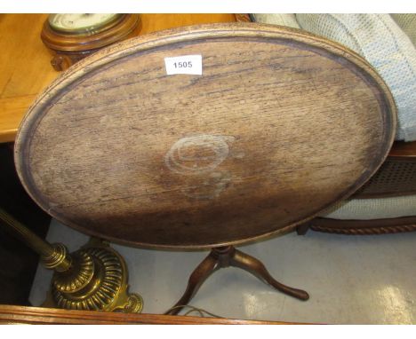 George III oak circular pedestal table with a dish top above a baluster turned column and tripod 