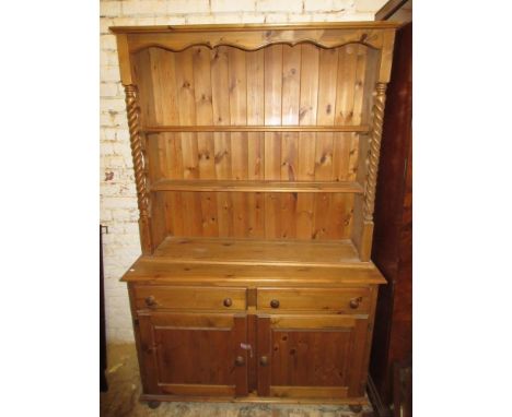 Small reproduction pine dresser with a boarded shelf back above two drawers and two cupboard doors, 47ins wide 