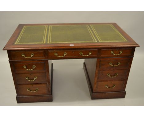 20th Century mahogany twin pedestal desk, the green tooled leather inset top above nine drawers with cast brass swan neck han