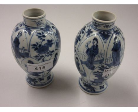 Pair of Chinese Kangxi blue and white lobed baluster form vases, painted with alternating panels of figures and flowers (rest