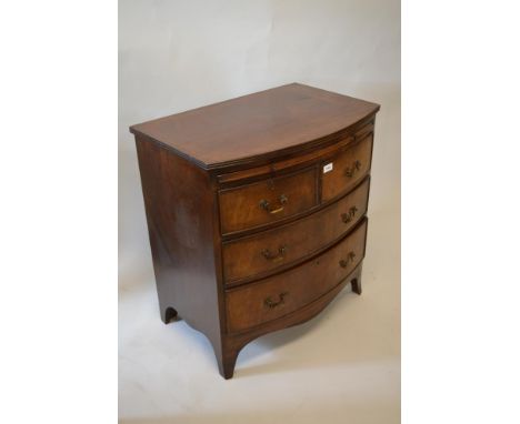 Mahogany dwarf bow front chest in George III style with a brushing slide above two short and two long drawers on bracket feet