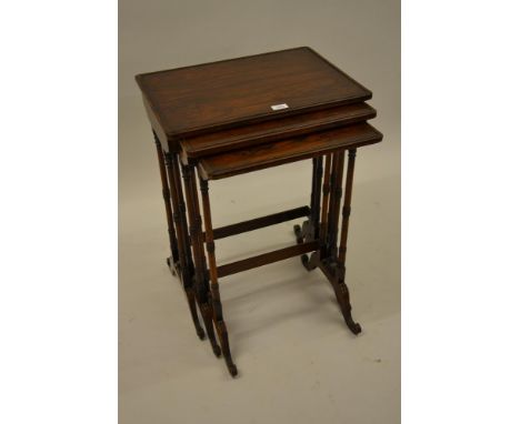 Nest of three William IV rectangular rosewood occasional tables on twin turned end supports with splay feet, stamped W. and C