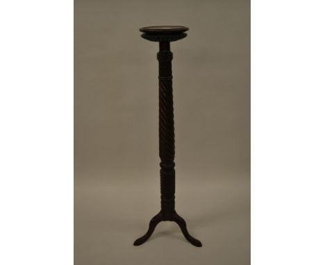19th Century carved mahogany bed post torchere with a circular top, wrythen column and tripod base 