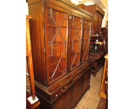 Reproduction mahogany bookcase, the moulded dentil cornice above three astragal glazed doors, the base with three drawers abo