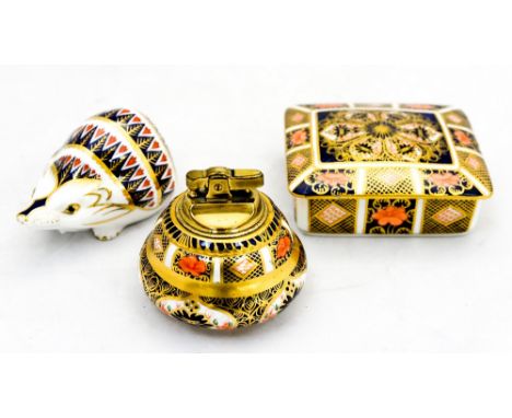 A Royal Crown Derby Imari palette table cigarette lighter box and cover 1128 and a hedgehog paperweight (3) 