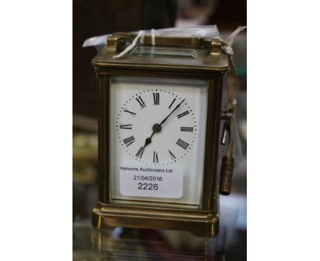 An Edwardian, possibly French brass and glass cased, carriage clock, enamel dial, Roman numerals, with key, working 