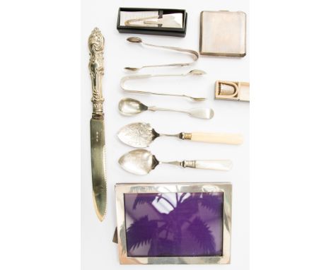 A silver rectangular photo frame, silver sugar tongs, silver thimble, silver compact and silver bookmark total gross weight 2