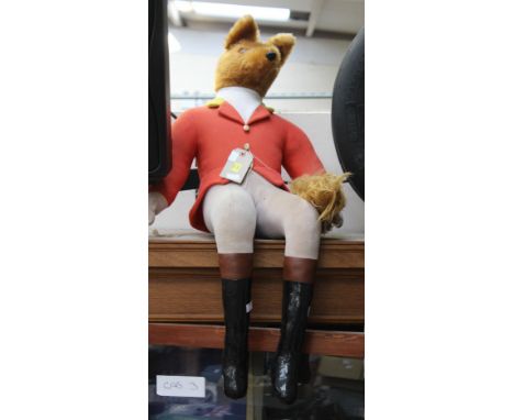 Pair of display foxes in hunting red coats.