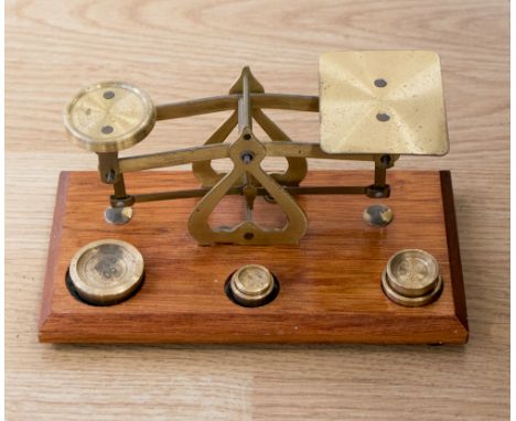 A set of brass postal scales with gram weights
