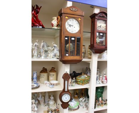 An early 20th Century beech cased wall clock, with a silvered dial and black Arabic numerals plus a barometer and thermometer