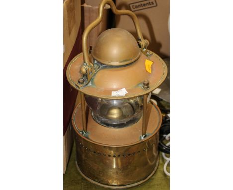 A brass ship's lamp having original magnifying glass, hanger to top and underside, 'Bulpim 1915' imprinted to underside  