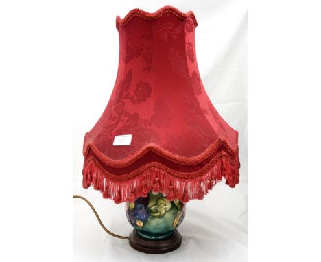 A Moorcroft 'Hibiscus' green ground table lamp, tube lined decoration, approx. 30cm high