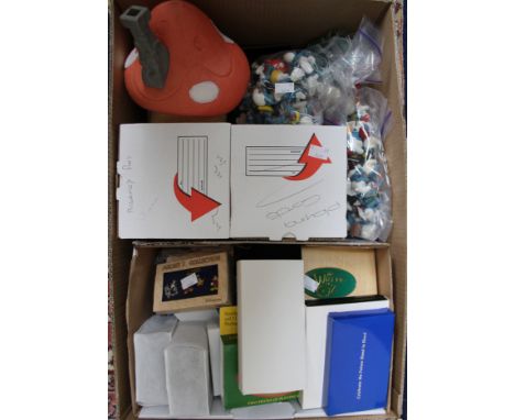 A box of coins, pin badges, playing cards etc