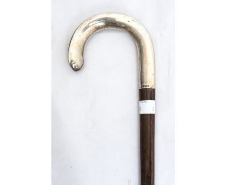 An early 20th Century walking stick of triangular outline with silver mount, London 1921