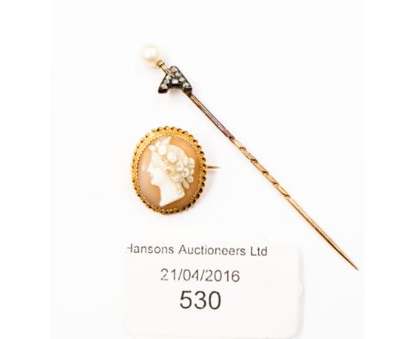 A pearl, diamond and rose metal stick pin with original box, together with a shell cameo classical design, yellow metal frame