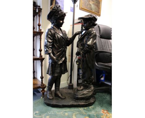 A modern bronzed finish floorstanding lamp in the form of an Edwardian boy and girl by a streetlight, height 172cm approx.