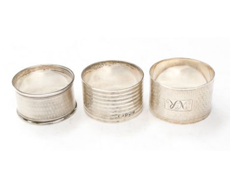 Three silver napkin rings, hallmarked for Birmingham, various years, all with engine-turned decoration, approx. 77g
