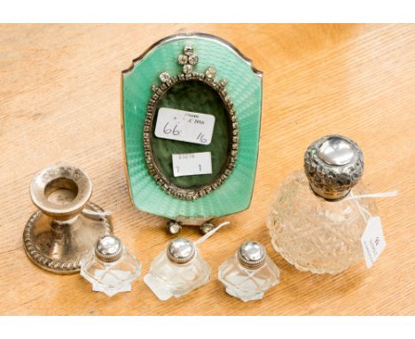 A weighted sterling silver short candlestick, silver capped hallmarked Birmingham 1904 scent bottle, three silver capped pepp