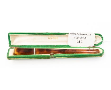 Cartier, an Art Deco celluloid tortoiseshell effect and diamond encrusted cigarette holder, circa 1920, in a fitted green lea