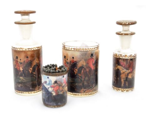 Two early 20th Century gold painted decanters with affixed hunting scenes, together with a small glass and vesta glass, match