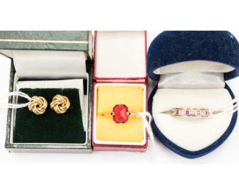 A 9ct white and yellow gold ruby and possibly white sapphire eternity ring, a pair of 9ct gold knot earrings and a 9ct gold d