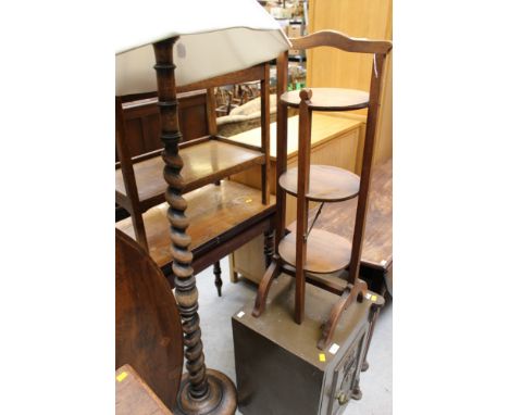 A 20th century oak standard lamp, the barley twist column standing on a circular platform base, together with a three-tier fo