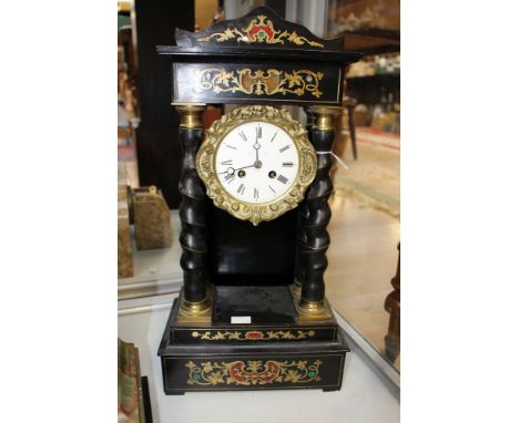 A French eight day ebonised and inlaid portico clock with movement chiming on hour and half hour 