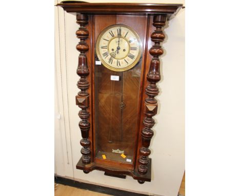 A late 19th century walnut Vienna wall clock, with an eight day double weight driven movement, the glazed door with applied s