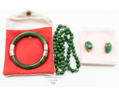 A jade bracelet with white metal mounts, a jade bead necklace with white metal mount set simulated pearl, together with a pai