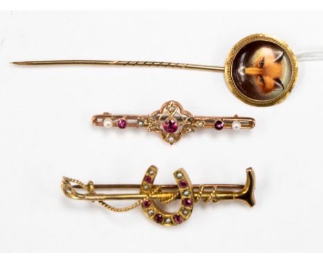 A stick pin, with circular porcelain finial enamelled fox mask together with a rose gold bar brooch and a horseshoe brooch 2.