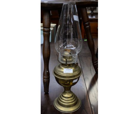A British made brass oil lamp with one inch wick, and glass chimney 