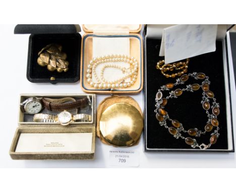 A white metal and amber necklace, Yardley compact, vine dress clip, a yellow metal bead and coral bead bracelet, clasp marked